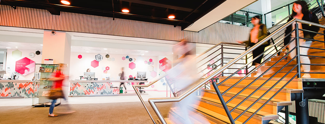 Blurred vision of students walking up and down stairs.